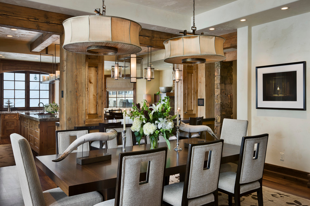 This is an example of a country kitchen/dining combo in Other with white walls and dark hardwood floors.