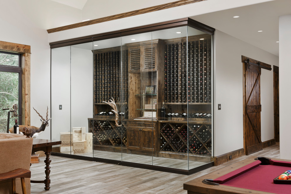 Inspiration for a country wine cellar in Houston with diamond bins and grey floor.