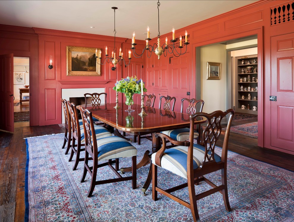 Country separate dining room in Philadelphia with red walls and dark hardwood floors.