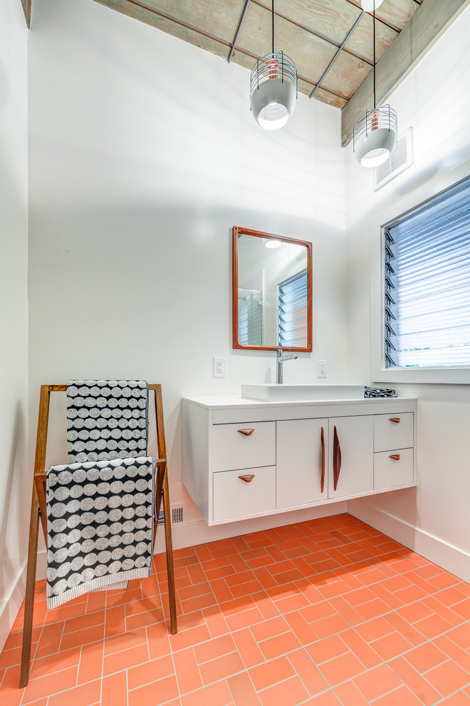 This is an example of a mid-sized midcentury 3/4 bathroom in San Francisco with flat-panel cabinets, white cabinets, a corner shower, white tile, ceramic tile, white walls, a vessel sink, engineered quartz benchtops, an open shower, white benchtops, brick floors and red floor.