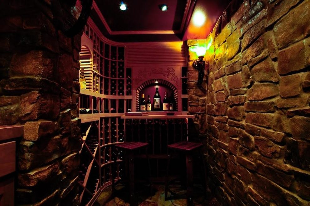 Wine cellar - small rustic brown floor wine cellar idea with storage racks