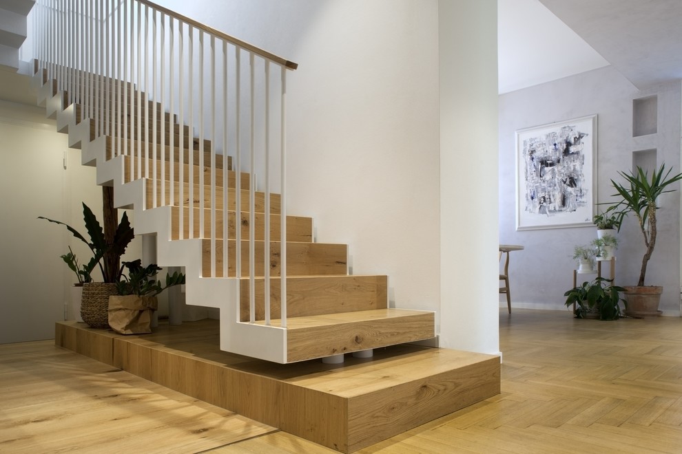Design ideas for a mid-sized contemporary wood floating staircase in Other with wood risers and metal railing.