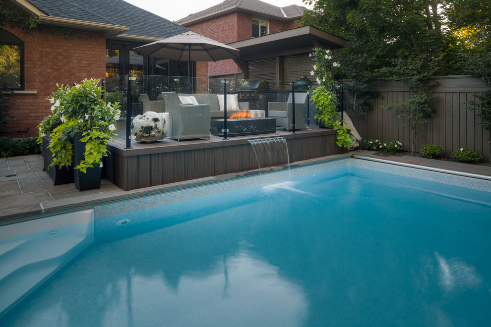 Inspiration for a mid-sized contemporary backyard full sun garden in Toronto with decking.