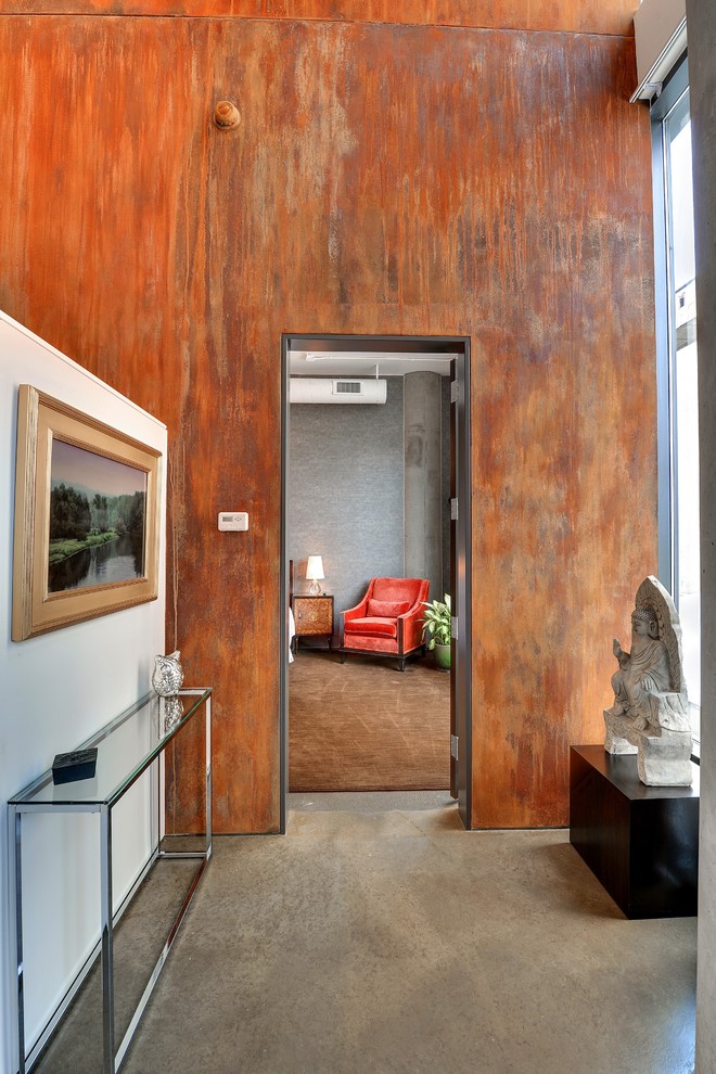 This is an example of a contemporary hallway in Minneapolis with concrete floors.