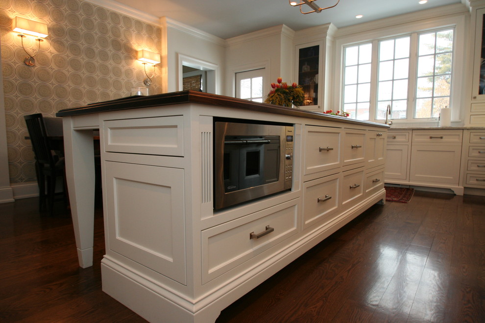 Large transitional l-shaped dark wood floor open concept kitchen photo in Chicago with flat-panel cabinets, white cabinets, granite countertops, blue backsplash, ceramic backsplash, stainless steel appliances and an island