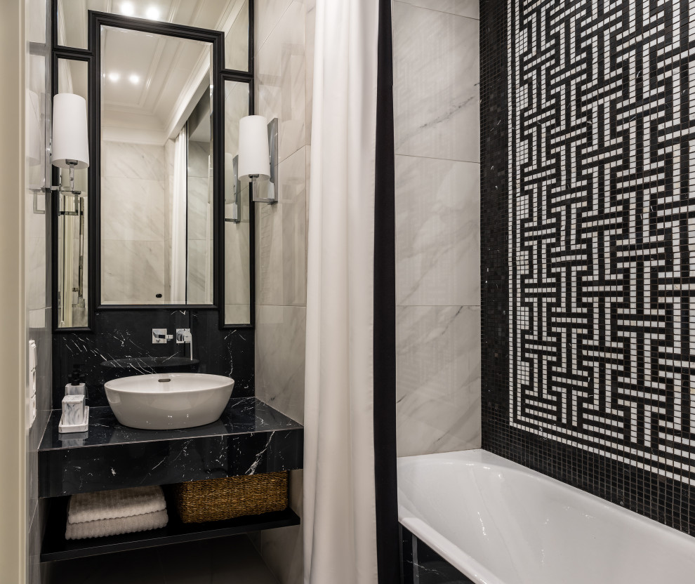 Источник вдохновения для домашнего уюта: ванная комната в современном стиле с черными фасадами, ванной в нише, белой плиткой, керамогранитной плиткой, белыми стенами, полом из керамической плитки, настольной раковиной, столешницей из плитки, белым полом, черной столешницей, нишей, тумбой под одну раковину и встроенной тумбой