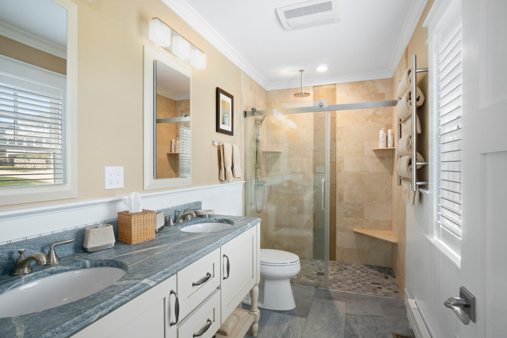 Inspiration for a small beach style master bathroom in Providence with shaker cabinets, white cabinets, a single vanity, a freestanding vanity, a double shower, a two-piece toilet, yellow walls, an undermount sink, a sliding shower screen, beige tile, marble floors, soapstone benchtops, blue floor, blue benchtops, a shower seat and decorative wall panelling.