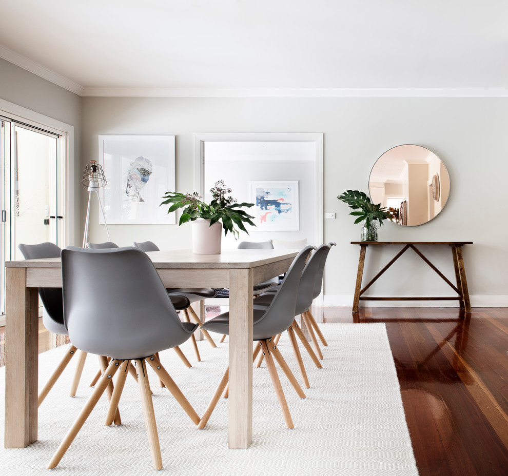 This is an example of a scandinavian dining room in Sydney with grey walls, dark hardwood floors and no fireplace.