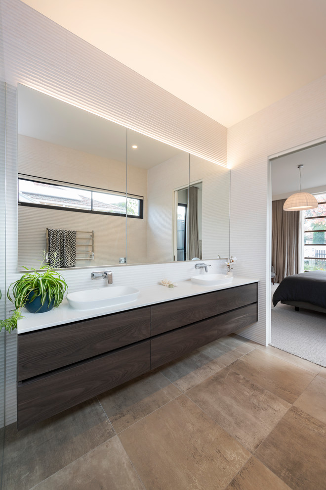 Design ideas for a contemporary wet room bathroom in Melbourne with flat-panel cabinets, dark wood cabinets, white tile, porcelain tile, white walls, porcelain floors, a drop-in sink, engineered quartz benchtops, brown floor, an open shower and white benchtops.