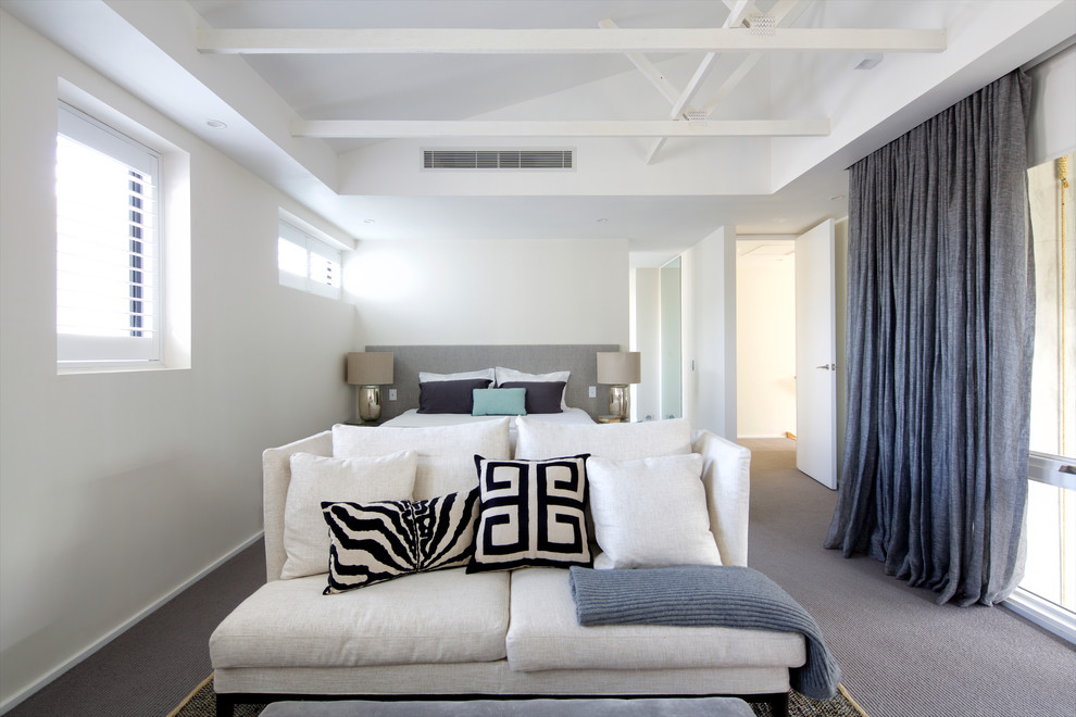 Photo of a large modern master bedroom in Sydney with carpet.