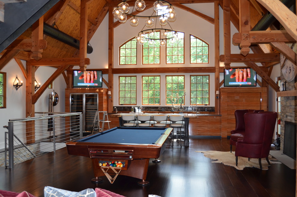 Photo of a large contemporary enclosed family room in New York with a game room, white walls, dark hardwood floors, a standard fireplace, a stone fireplace surround, a freestanding tv and brown floor.