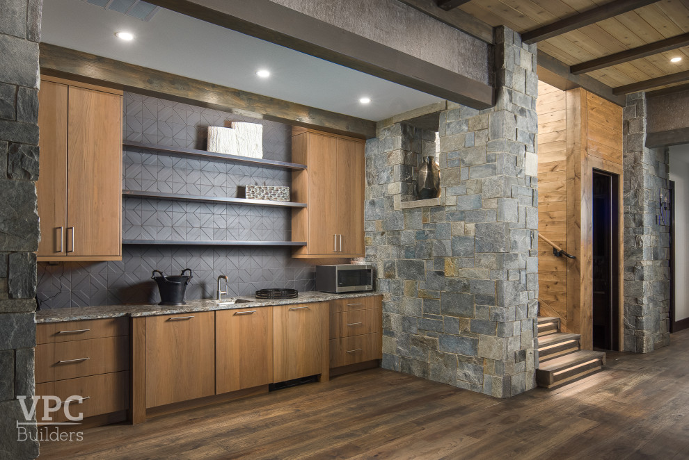 Photo of a mid-sized contemporary single-wall wet bar in Charlotte with an integrated sink, grey splashback and medium hardwood floors.