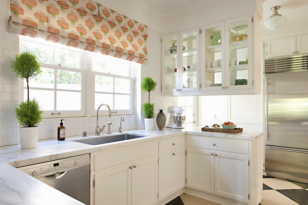 Inspiration for a traditional u-shaped kitchen in Los Angeles with an undermount sink, white cabinets, white splashback, subway tile splashback, stainless steel appliances, a peninsula, multi-coloured floor, white benchtop and shaker cabinets.