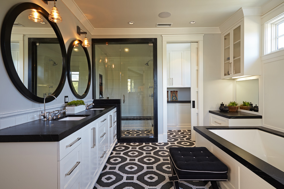 Design ideas for a large transitional bathroom in Orange County with an undermount sink, white cabinets, an undermount tub, black tile, mosaic tile, a corner shower, soapstone benchtops, grey walls, mosaic tile floors, shaker cabinets and black floor.