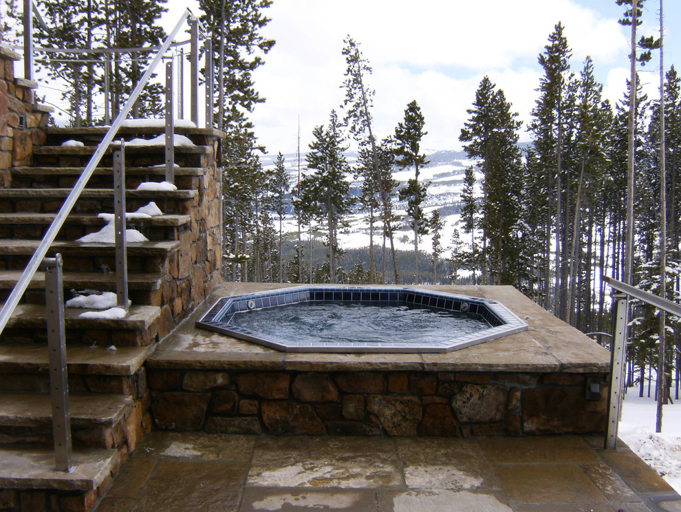 Hot tub - rustic side yard stone aboveground hot tub idea