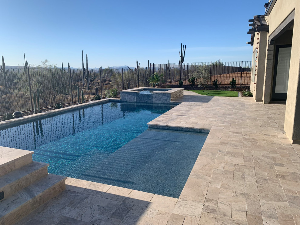 Large transitional backyard stone and custom-shaped hot tub photo in Phoenix