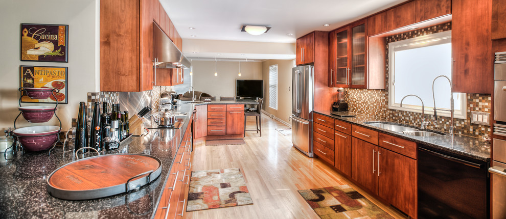 Inspiration for a large transitional l-shaped light wood floor eat-in kitchen remodel in Indianapolis with flat-panel cabinets, medium tone wood cabinets, multicolored backsplash, stainless steel appliances, a drop-in sink and no island