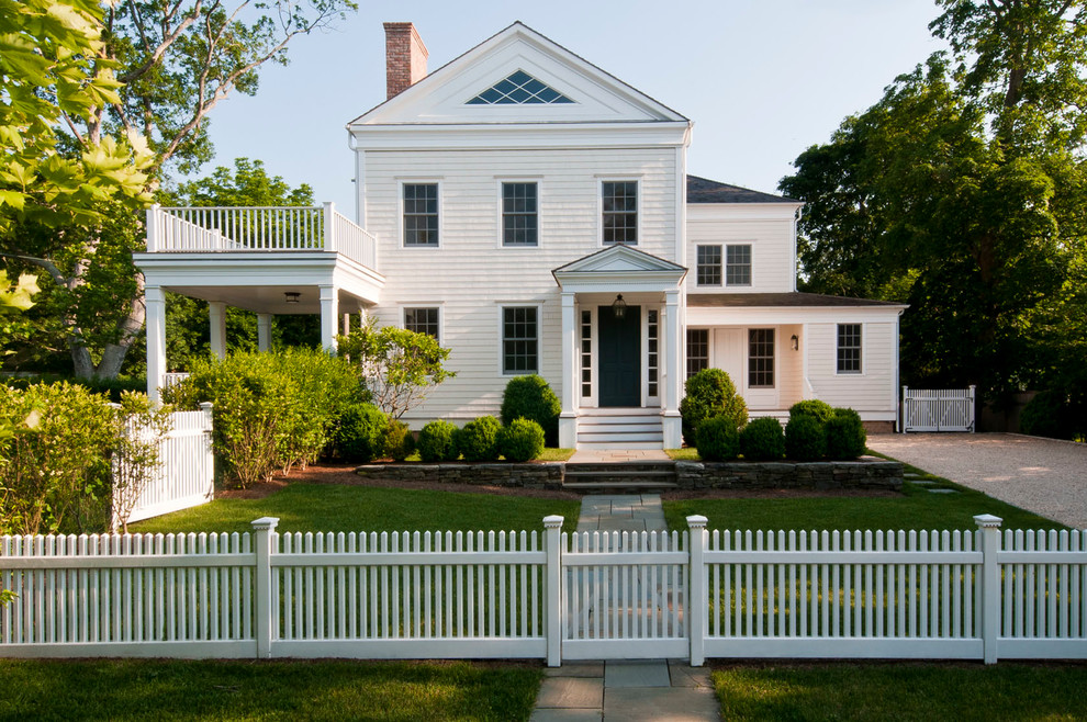 This is an example of a mid-sized traditional two-storey white house exterior in New York with wood siding, a gable roof and a shingle roof.