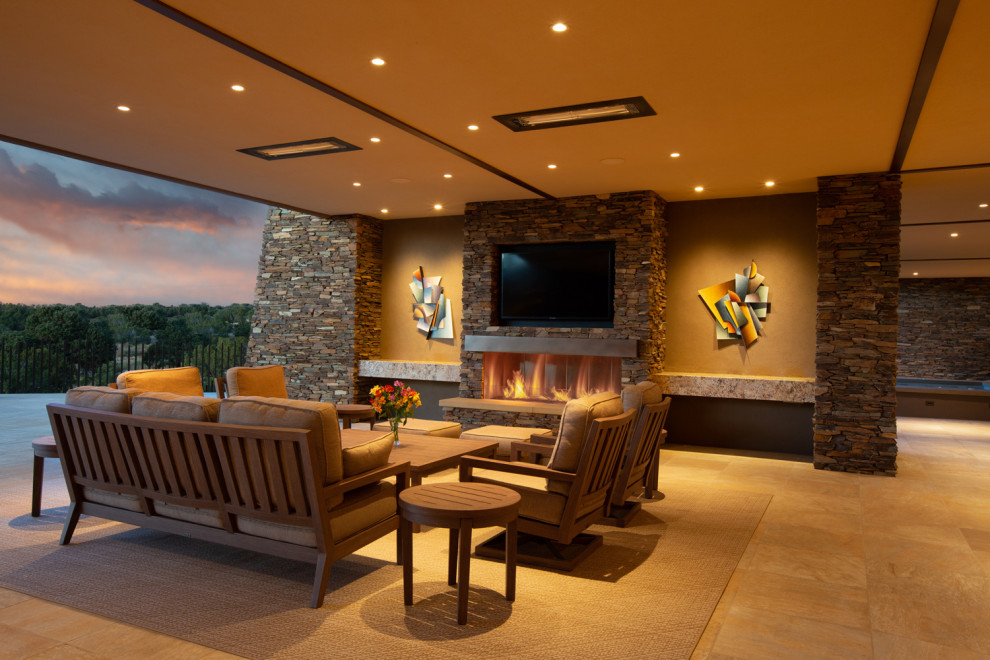 Inspiration for a mid-sized contemporary backyard patio remodel in Phoenix with a fireplace and a roof extension