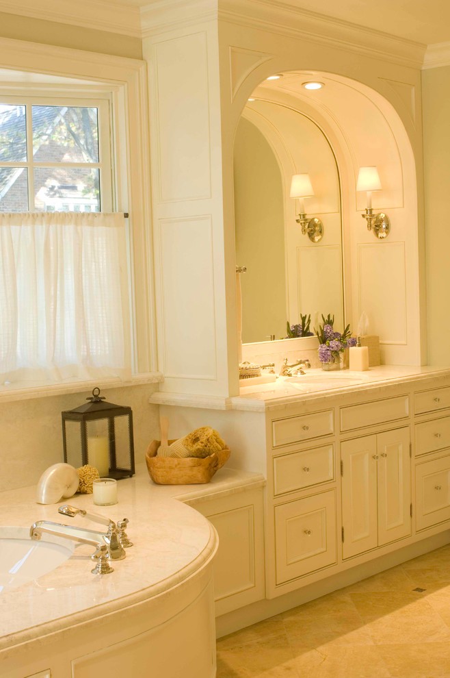 This is an example of a mid-sized traditional master bathroom in Chicago with a console sink, raised-panel cabinets, white cabinets, marble benchtops, a corner tub, green walls and ceramic floors.