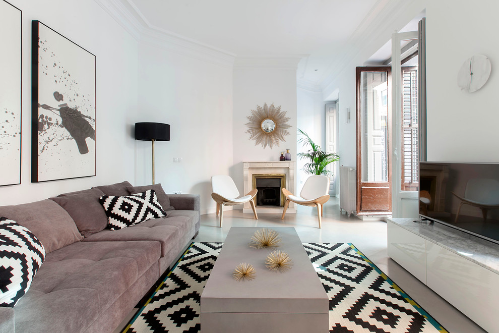 Inspiration for a large contemporary formal enclosed living room in Madrid with white walls, concrete floors, a freestanding tv, a standard fireplace and a stone fireplace surround.