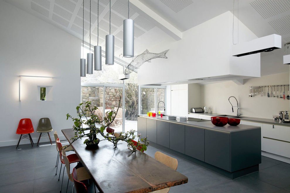 Large contemporary galley eat-in kitchen in Paris with a double-bowl sink, flat-panel cabinets, white cabinets and with island.