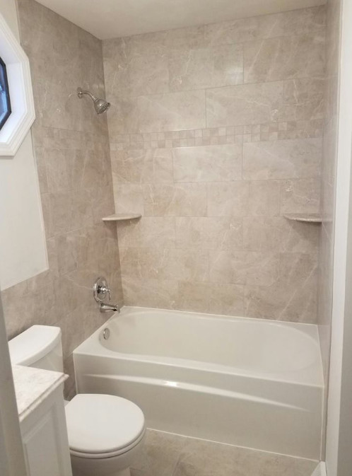 Mid-sized transitional white tile and porcelain tile porcelain tile and beige floor alcove bathtub photo with raised-panel cabinets, white cabinets, a two-piece toilet, beige walls, an undermount sink, marble countertops and white countertops