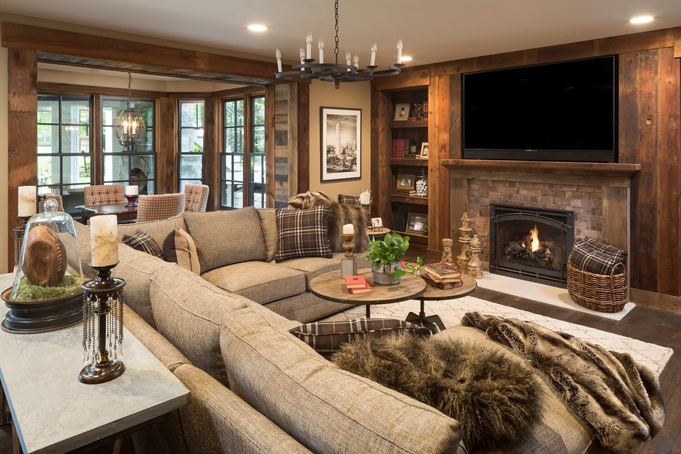 Inspiration for a traditional living room in Minneapolis with brown walls, dark hardwood floors, a standard fireplace and a brick fireplace surround.