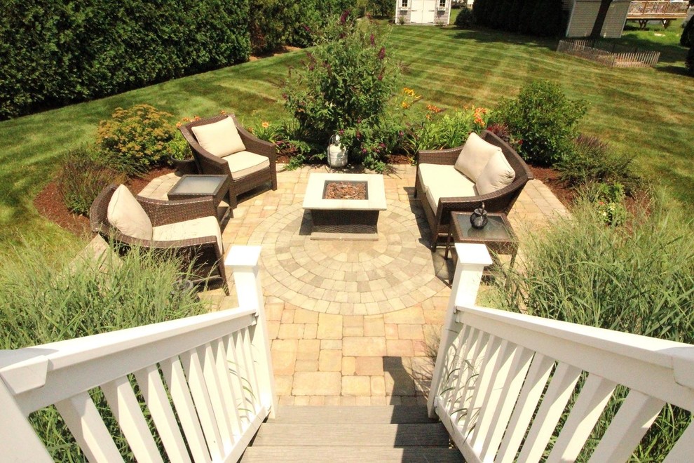 Inspiration for a backyard concrete paver patio remodel with no cover
