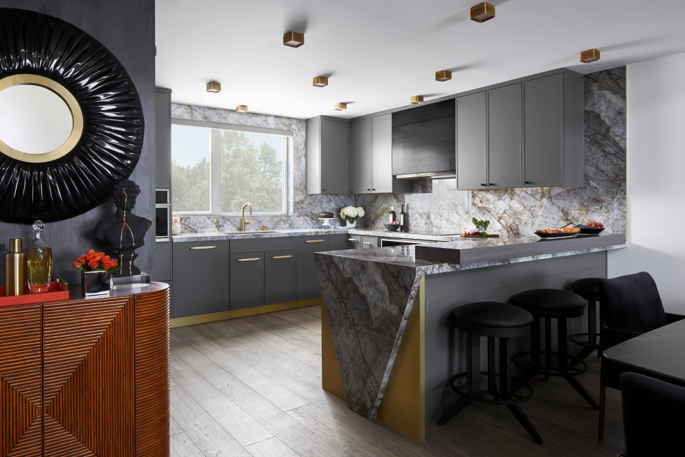 Design ideas for a mid-sized modern u-shaped eat-in kitchen in Los Angeles with a single-bowl sink, shaker cabinets, grey cabinets, solid surface benchtops, grey splashback, porcelain splashback, stainless steel appliances, laminate floors, a peninsula, grey floor and grey benchtop.