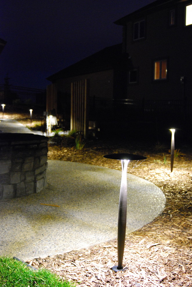 Photo of a mid-sized rustic front yard concrete paver garden path in Calgary.