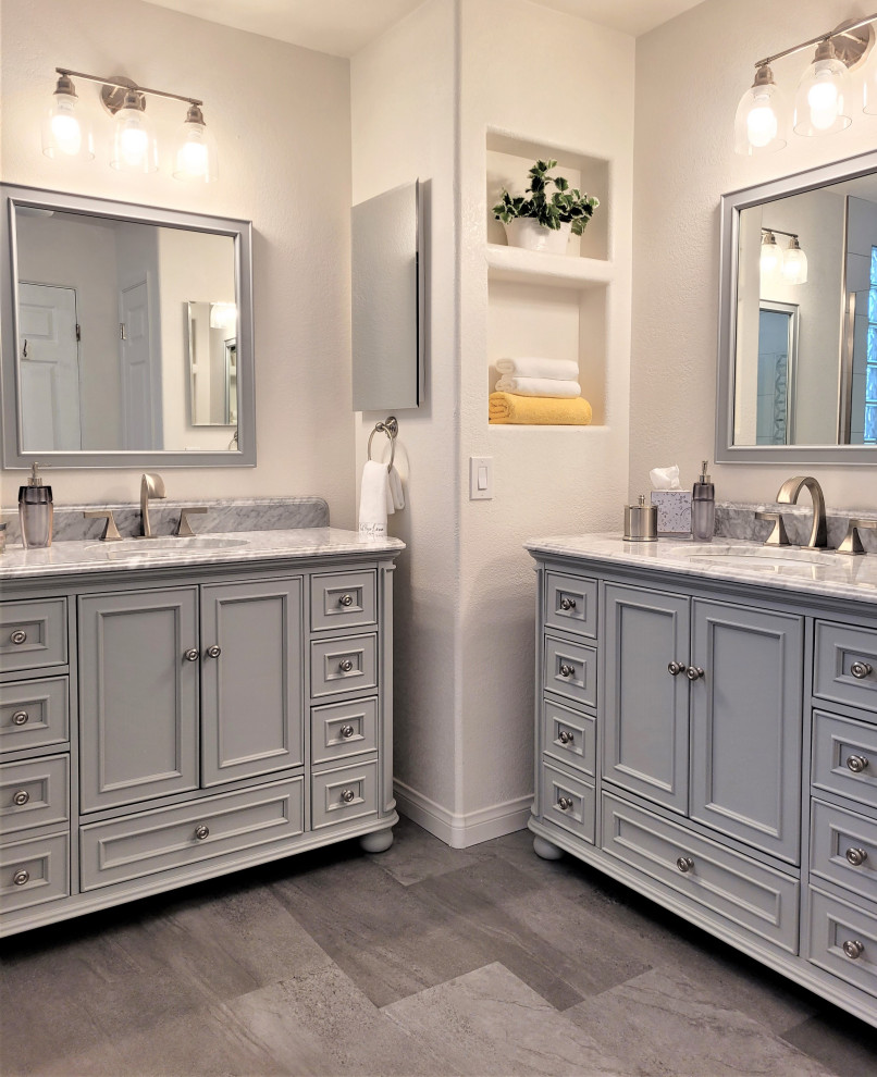 Design ideas for a mid-sized traditional bathroom in Los Angeles with recessed-panel cabinets, grey cabinets, an alcove shower, white tile, ceramic tile, beige walls, linoleum floors, an undermount sink, marble benchtops, grey floor, a hinged shower door, grey benchtops, a single vanity and a freestanding vanity.