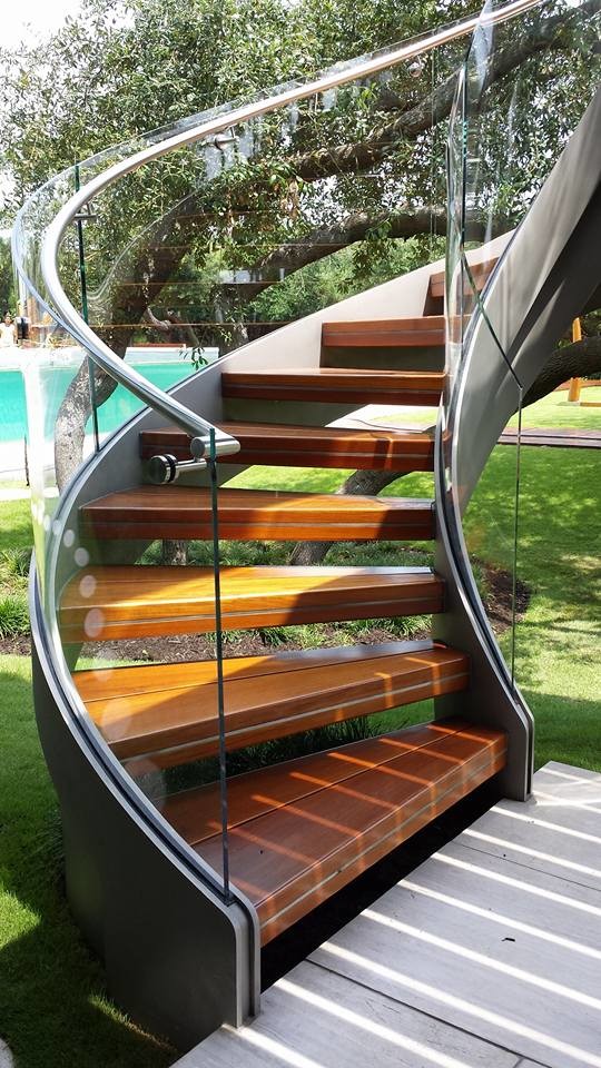 Inspiration for a contemporary wood staircase in Charleston with open risers and metal railing.