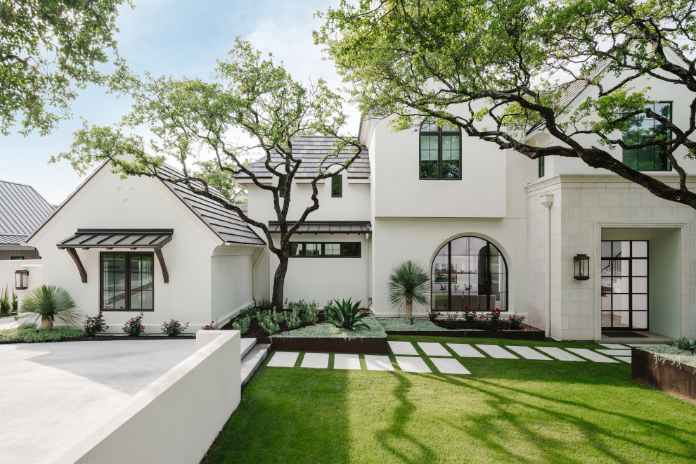 Expansive mediterranean two-storey white house exterior in Austin with mixed siding, a gable roof and a mixed roof.