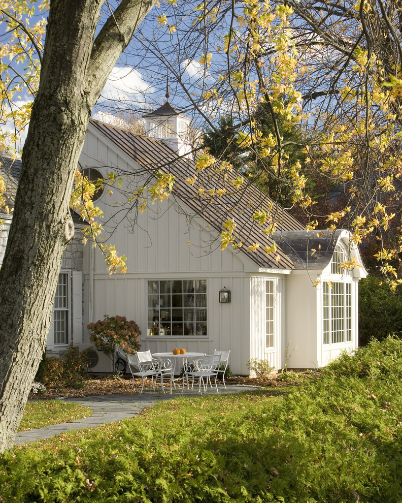 This is an example of a country white exterior in Burlington with wood siding.