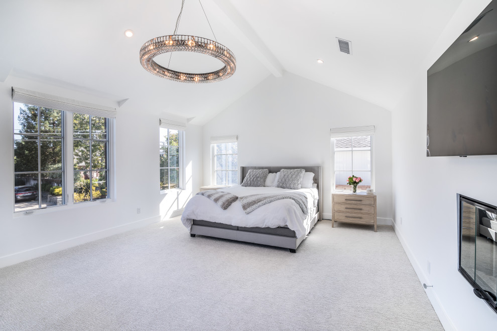Design ideas for a large modern master bedroom in San Francisco with white walls, carpet, a two-sided fireplace, grey floor and vaulted.