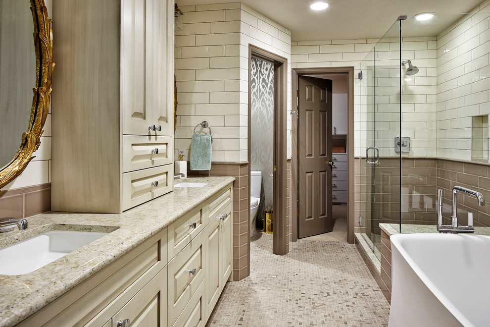 Design ideas for a transitional bathroom in Denver with an undermount sink, raised-panel cabinets, beige cabinets, a freestanding tub, a corner shower, multi-coloured tile, a two-piece toilet, subway tile, multi-coloured walls, beige floor, a hinged shower door, beige benchtops and an enclosed toilet.