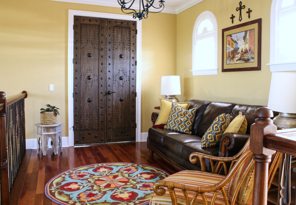 This is an example of a mediterranean family room in Tampa with yellow walls.