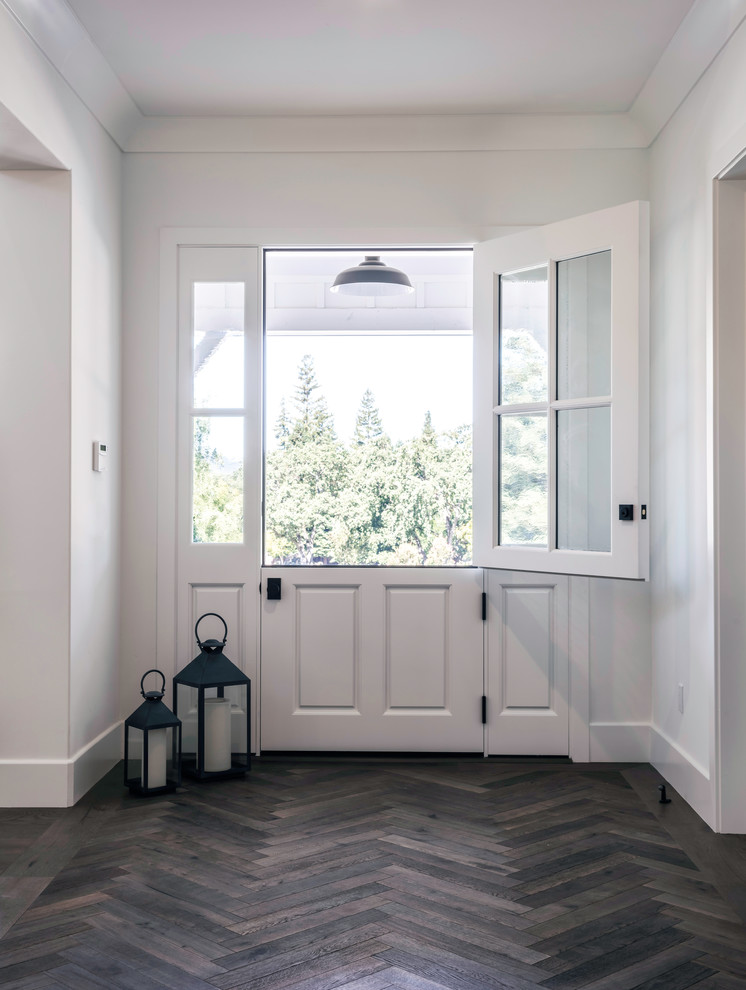 Inspiration for a mid-sized country foyer in San Francisco with white walls, medium hardwood floors, a dutch front door, a white front door and brown floor.