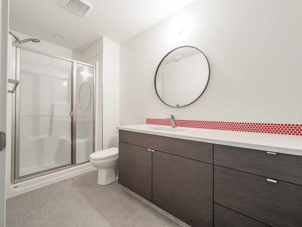 Design ideas for a mid-sized scandinavian 3/4 bathroom in Edmonton with flat-panel cabinets, medium wood cabinets, an alcove shower, a two-piece toilet, red tile, porcelain tile, white walls, vinyl floors, a drop-in sink, quartzite benchtops, grey floor and a hinged shower door.