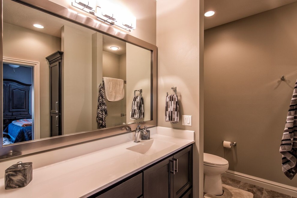 Mid-sized transitional 3/4 gray tile and porcelain tile porcelain tile bathroom photo with beaded inset cabinets, black cabinets, beige walls, an integrated sink and quartz countertops