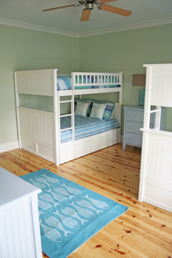 Photo of a mid-sized transitional guest bedroom in Charleston with green walls and light hardwood floors.
