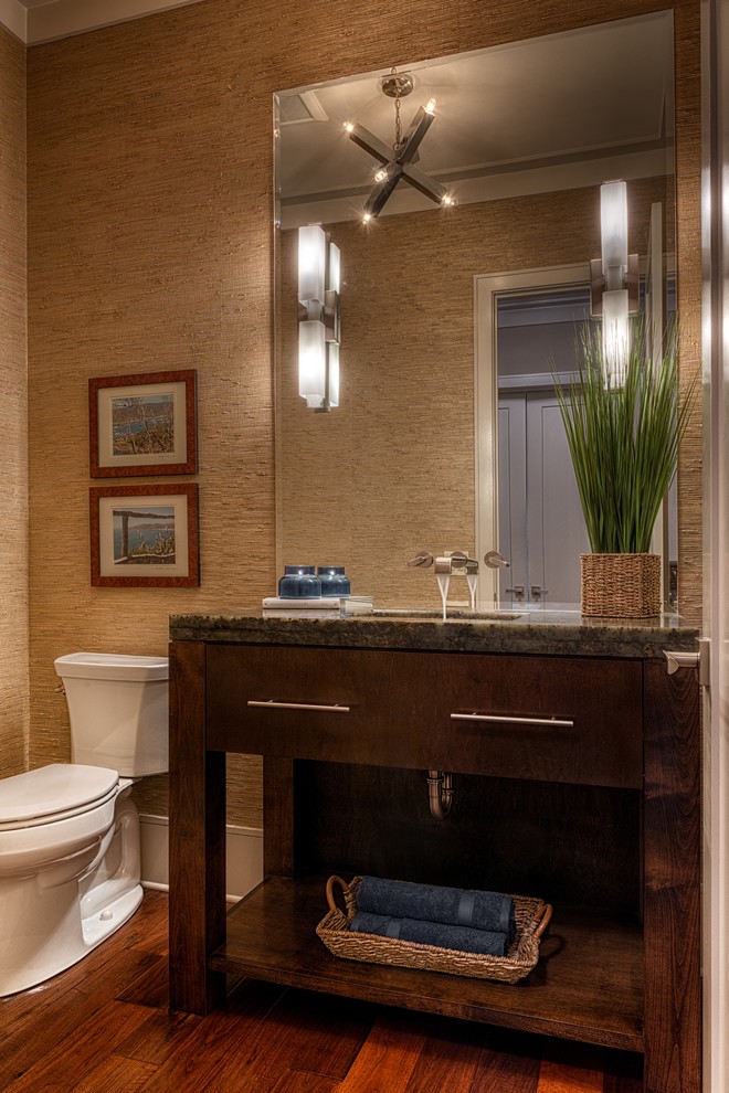 Photo of a large modern powder room in Other with an undermount sink, flat-panel cabinets, granite benchtops, a two-piece toilet, medium hardwood floors and dark wood cabinets.