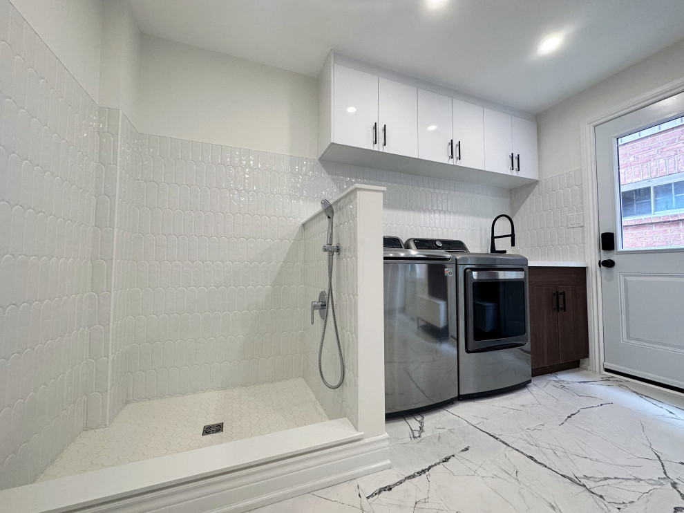 This is an example of a large contemporary laundry room in Toronto with an undermount sink, flat-panel cabinets, dark wood cabinets, quartzite benchtops, white splashback, ceramic splashback, white walls, porcelain floors, a side-by-side washer and dryer, multi-coloured floor and white benchtop.