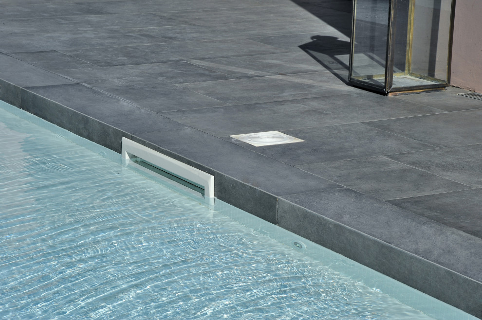 Photo of a modern rectangular pool with with a pool and tile.