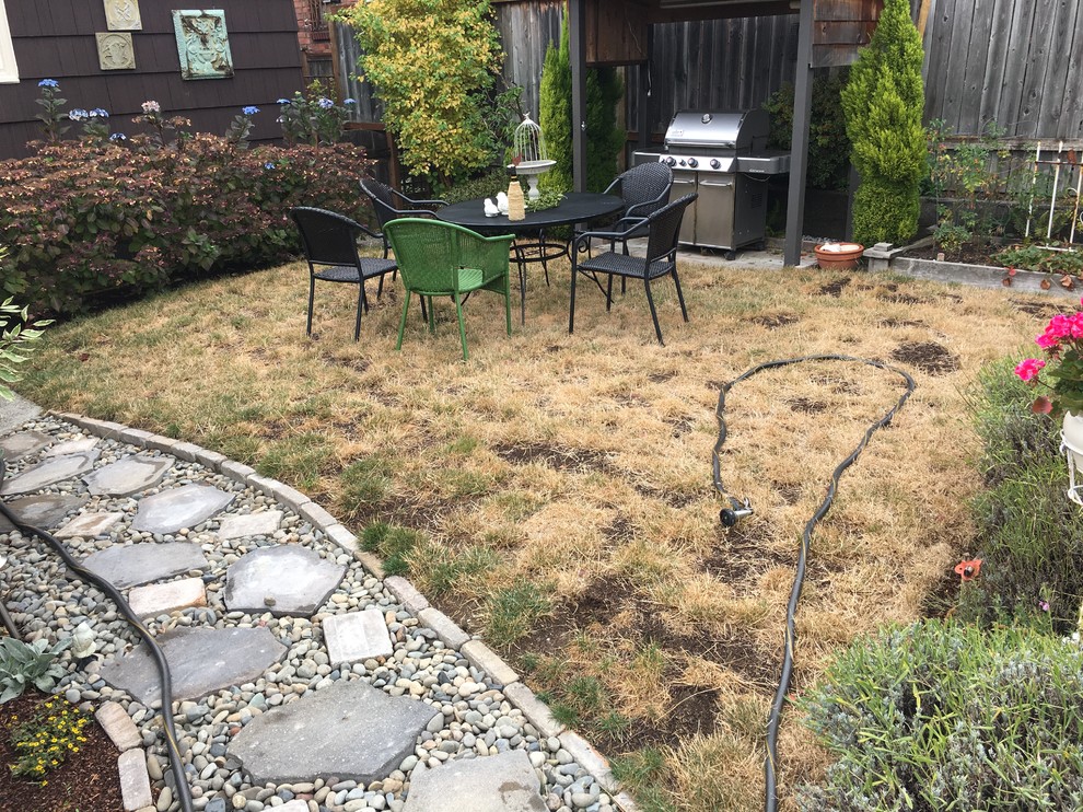 Photo of a full sun backyard stone formal garden in Seattle for spring.
