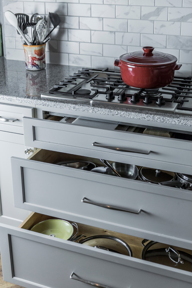Example of a large transitional single-wall dark wood floor home design design in Boston with an undermount sink, flat-panel cabinets, gray cabinets, granite countertops, white backsplash, ceramic backsplash, stainless steel appliances and an island