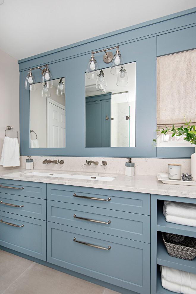 Mid-sized transitional white tile and stone slab ceramic tile, gray floor and double-sink bathroom photo in Toronto with shaker cabinets, blue cabinets, a one-piece toilet, gray walls, an undermount sink, quartz countertops, a hinged shower door, white countertops, a niche and a built-in vanity