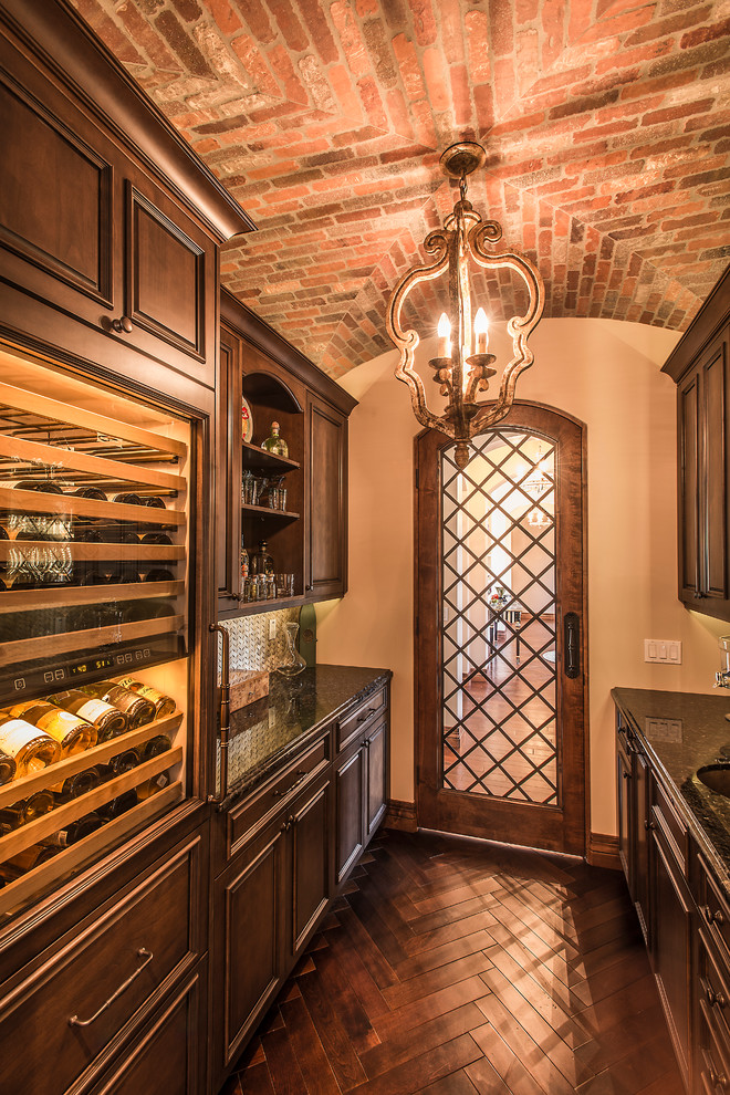 Inspiration for a mid-sized traditional wine cellar in Phoenix with dark hardwood floors, brown floor and display racks.