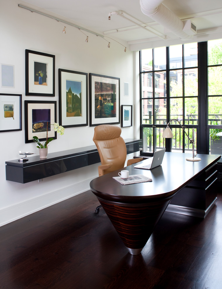 This is an example of a large contemporary study room in Other with white walls, dark hardwood floors, no fireplace, a freestanding desk and brown floor.